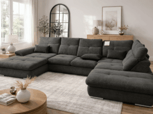 Canapé panoramique gris anthracite en velours côtelé dans un salon moderne et lumineux avec tapis beige.