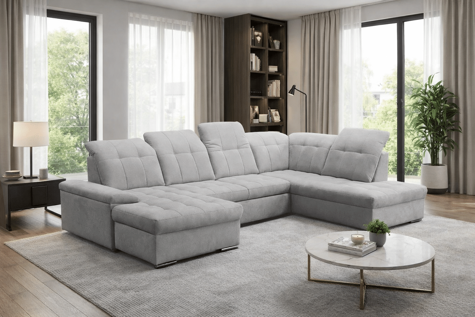 Grand canapé d'angle en U gris clair capitonné dans un salon moderne avec table basse en marbre et tapis gris.